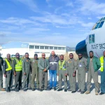 Crew of Nigerian Air Force C-130 transport aircraft at an airfield en route to OGMA maintenance facility in Portugal.