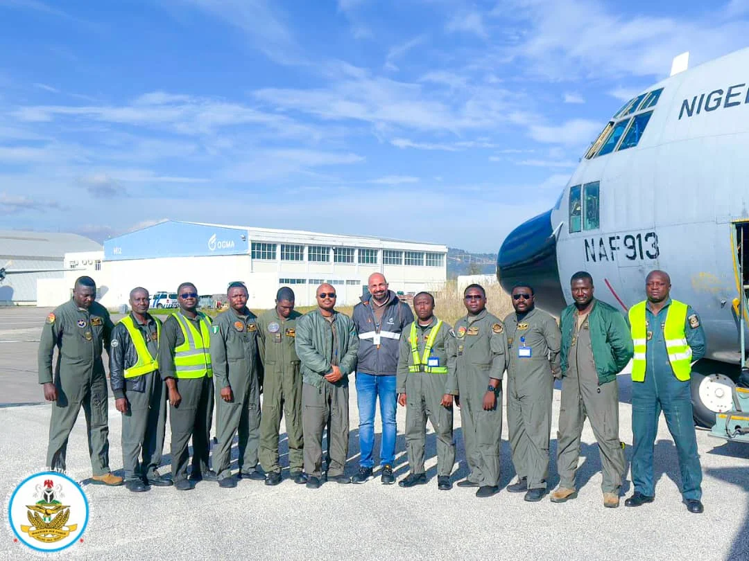 Crew of Nigerian Air Force C-130 transport aircraft at an airfield en route to OGMA maintenance facility in Portugal.