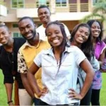 Young Nigerians using smartphones and laptops, representing online political engagement and social media discussions.