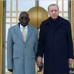 President Tinubu being held by the wrist by his host, President Recep Tayyib Erdogan of Turkiye